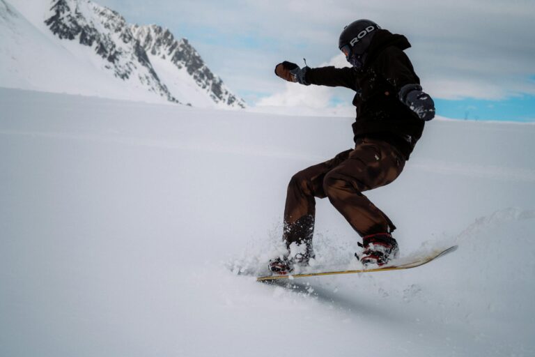An adventurous snowboarder carving through snow in Saint-François-Longchamp, showcasing winter sports enthusiasm.
